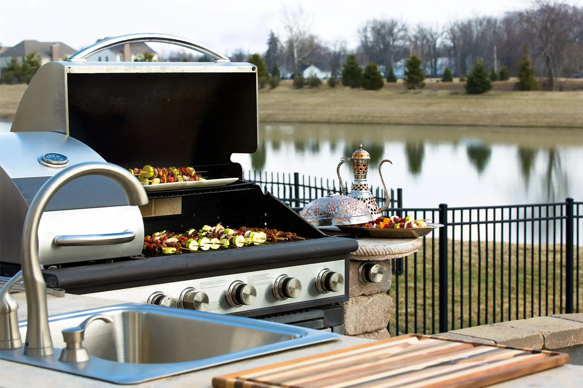 an inviting outdoor kitchen space featuring a grill surrounded by fresh vegetables, ready for a gourmet cooking experience under the sky