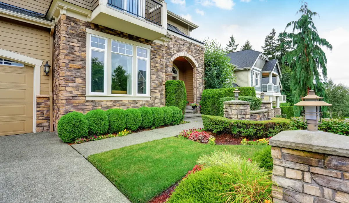 Beautiful front yard eco-friendly landscaping projects in Lisle, IL, with well-maintained shrubs and a stone pathway for a low-maintenance outdoor space.