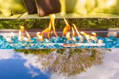 a cozy gas fire pit area with comfortable seating, reflecting the tranquility of the surrounding trees, perfect for evening relaxation